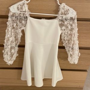 White dress with beautiful flowers details in sleeves